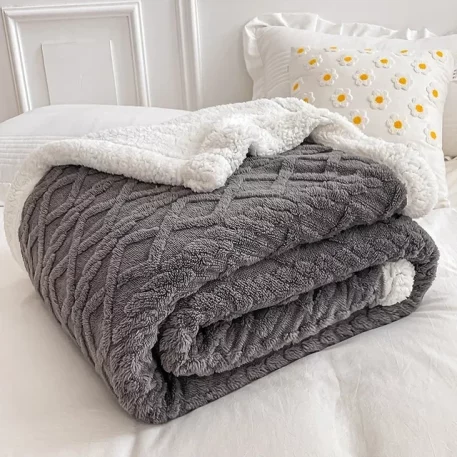 Embrace our Woven Lamb Wool Fleece Plush Throw Blanket, a must-have for anyone who craves style & coziness in their home. Experience warmth and elegance.