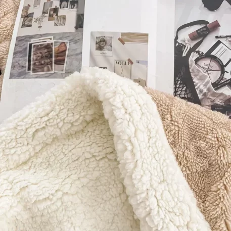 Embrace our Woven Lamb Wool Fleece Plush Throw Blanket, a must-have for anyone who craves style & coziness in their home. Experience warmth and elegance.