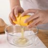 Egg yolk being separated from egg white with an egg separator