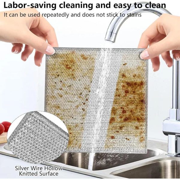 Double-sided metal mesh scrubbing cloth on a greasy surface